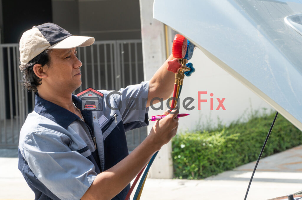 A man cleaning the hood of a car.