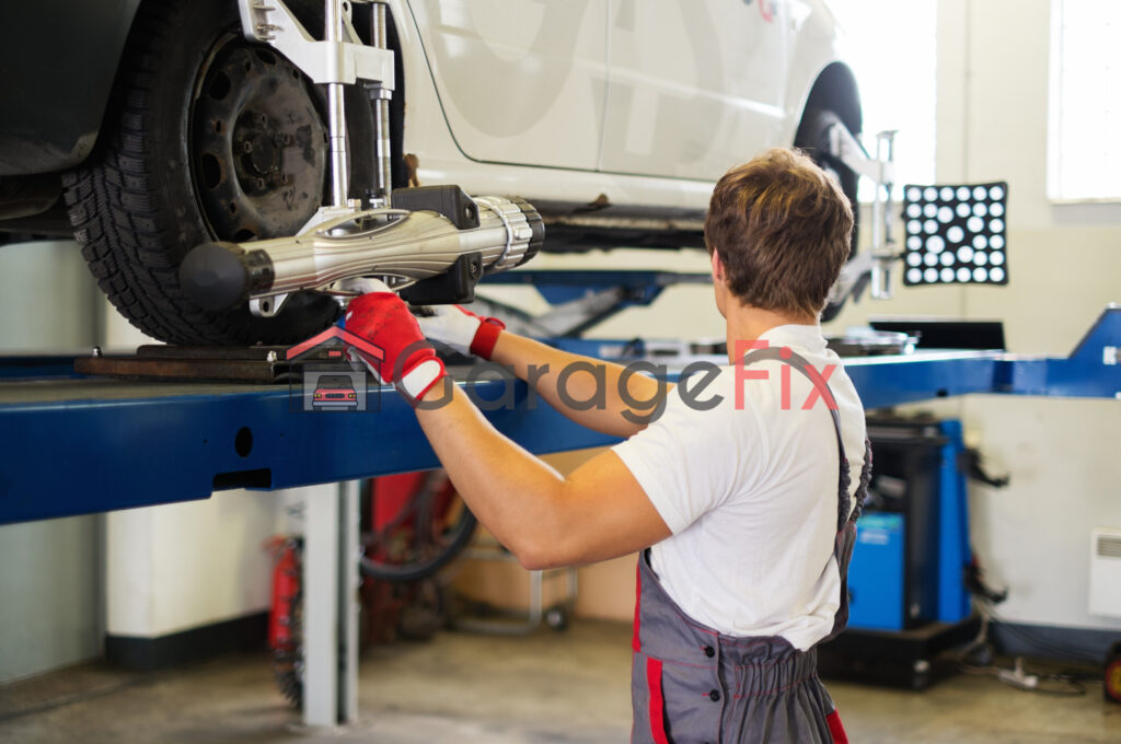 A mechanic working on a car in a garage.