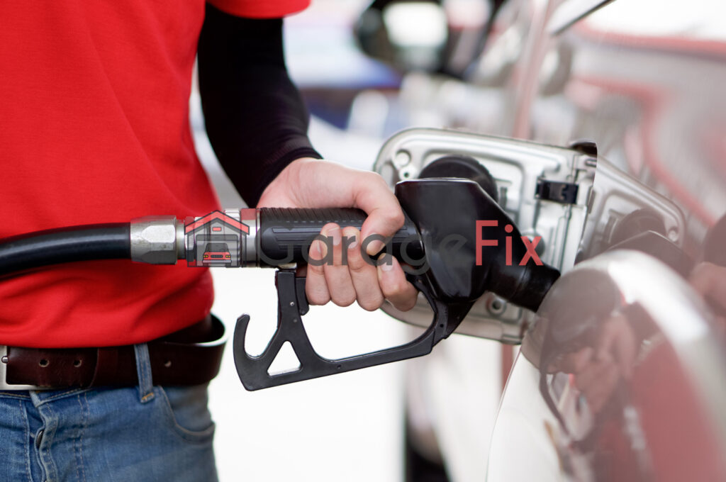 A man filling up his car with gas.