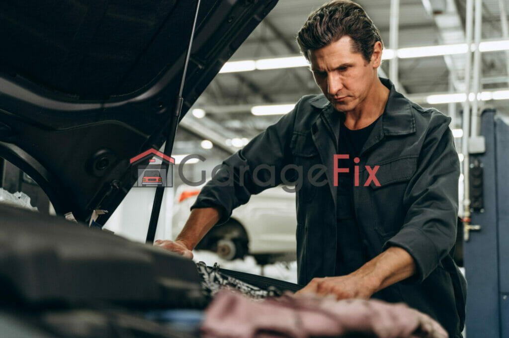 A mechanic working on a car in a garage.