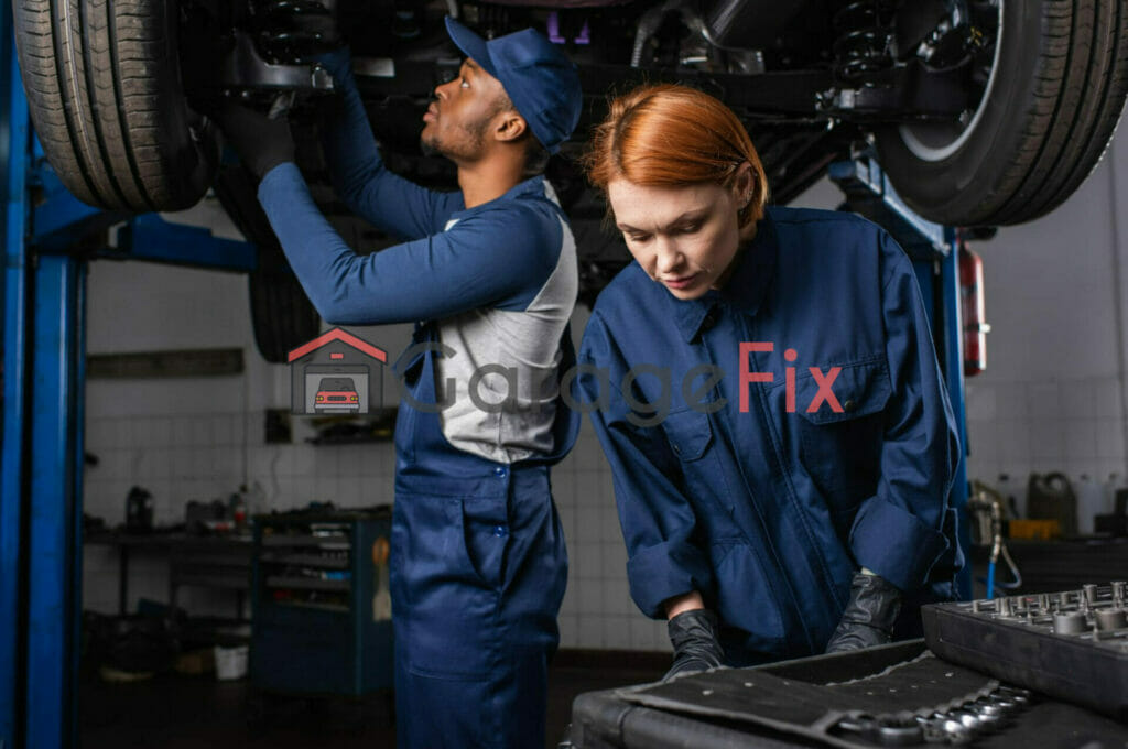 Two mechanics working on a car in a garage.