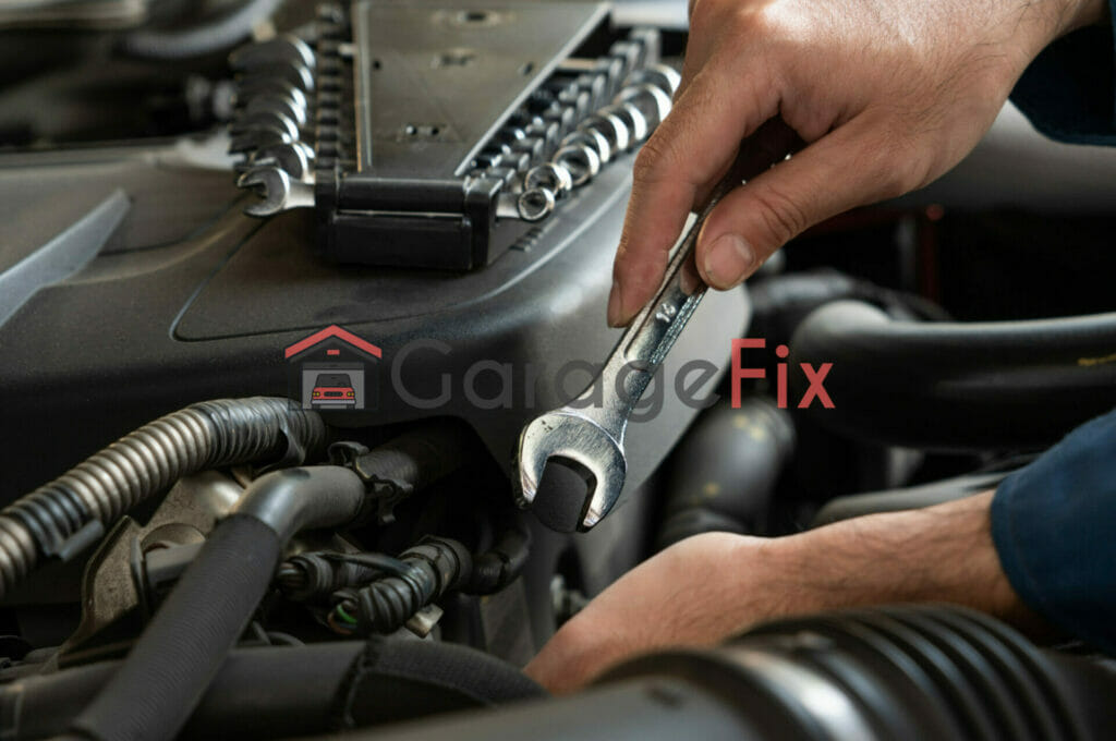 A man is working on the engine of a car.