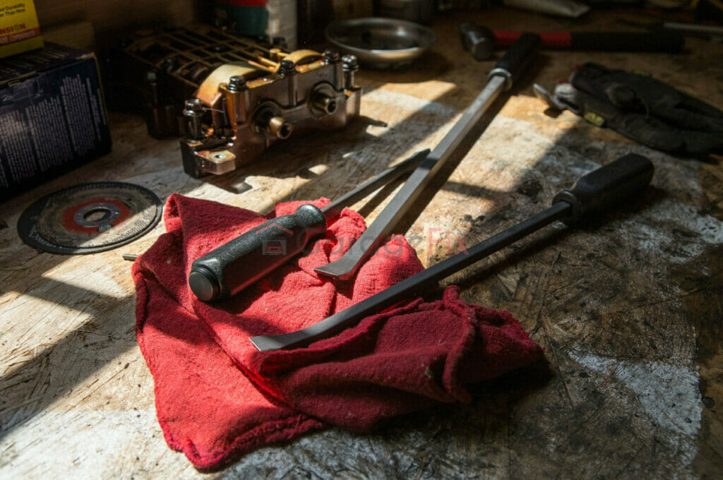 Wrenches and tools on a table in a garage.