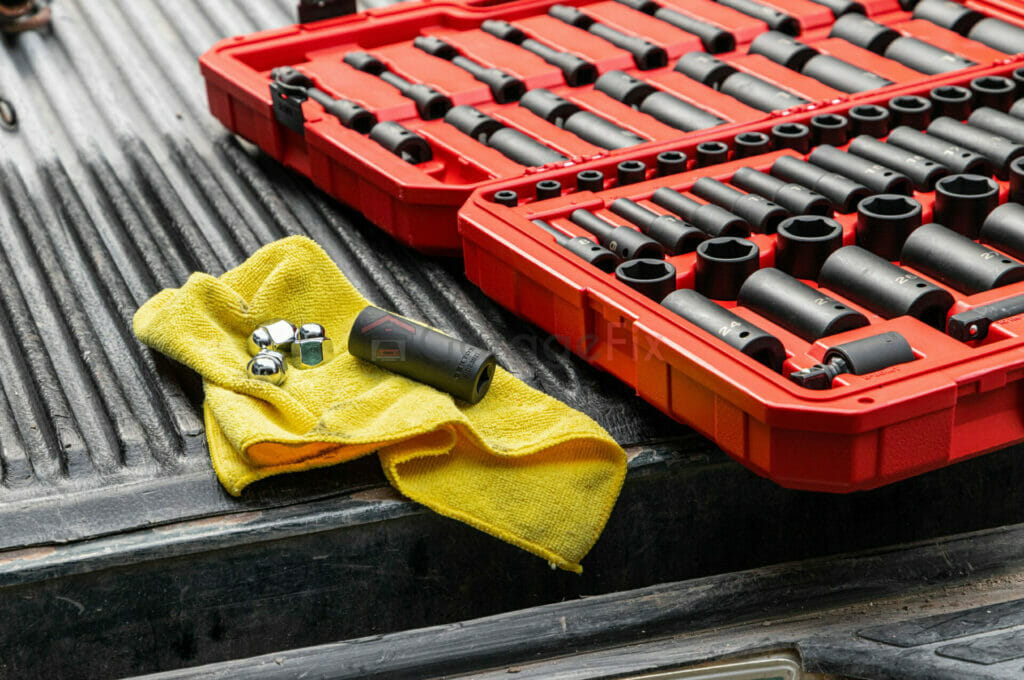 A set of wrenches and sockets on the bed of a truck.